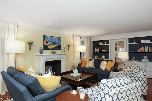 living room with built in shelves and crown molding