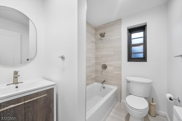 full bathroom with toilet, vanity, and tiled shower / bath combo