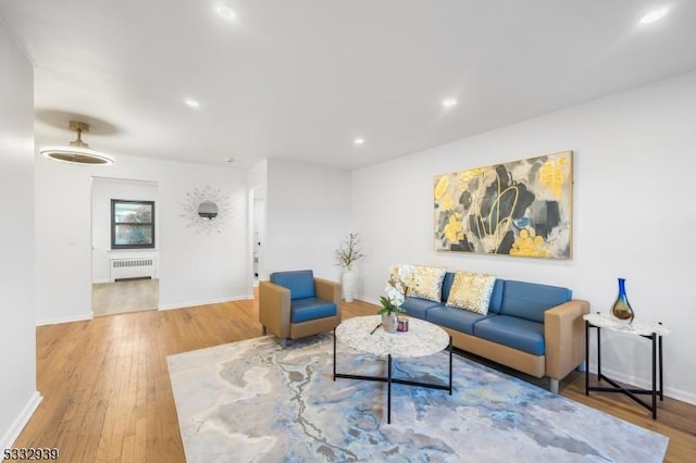 living room with hardwood / wood-style floors and radiator heating unit