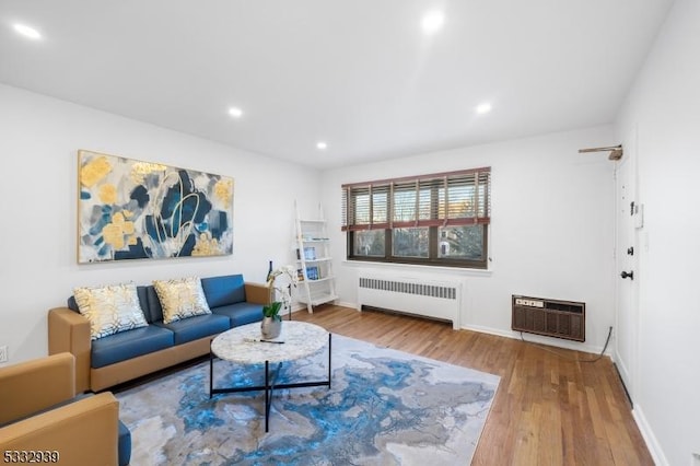 living room featuring radiator, heating unit, and hardwood / wood-style flooring