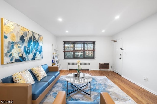 living room with radiator heating unit and hardwood / wood-style floors