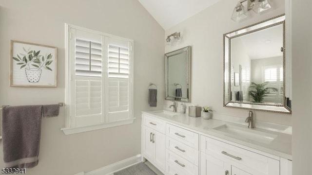 bathroom with vanity and vaulted ceiling