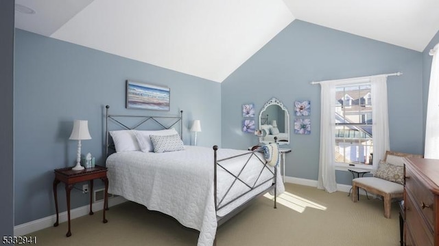 carpeted bedroom with vaulted ceiling