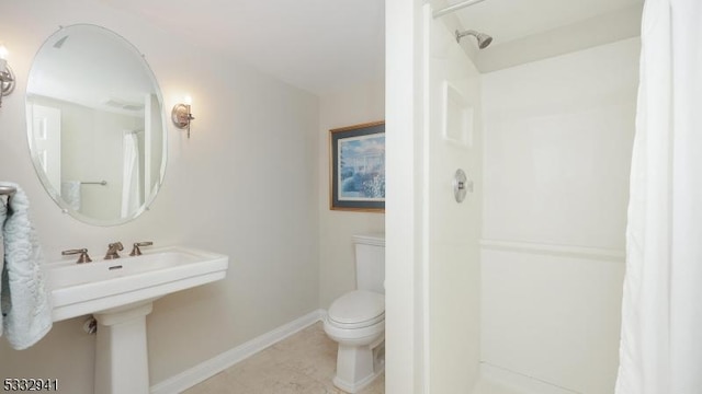 bathroom with toilet, tile patterned flooring, and a shower with curtain