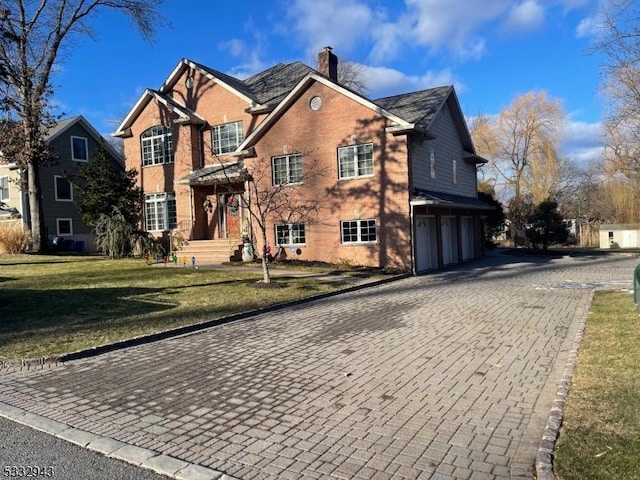 view of property with a front lawn and a garage