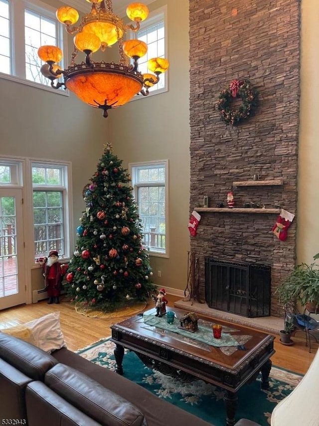 living room with a fireplace, wood-type flooring, and plenty of natural light