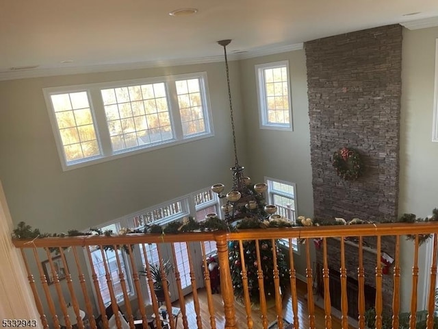 stairs featuring ornamental molding and a chandelier