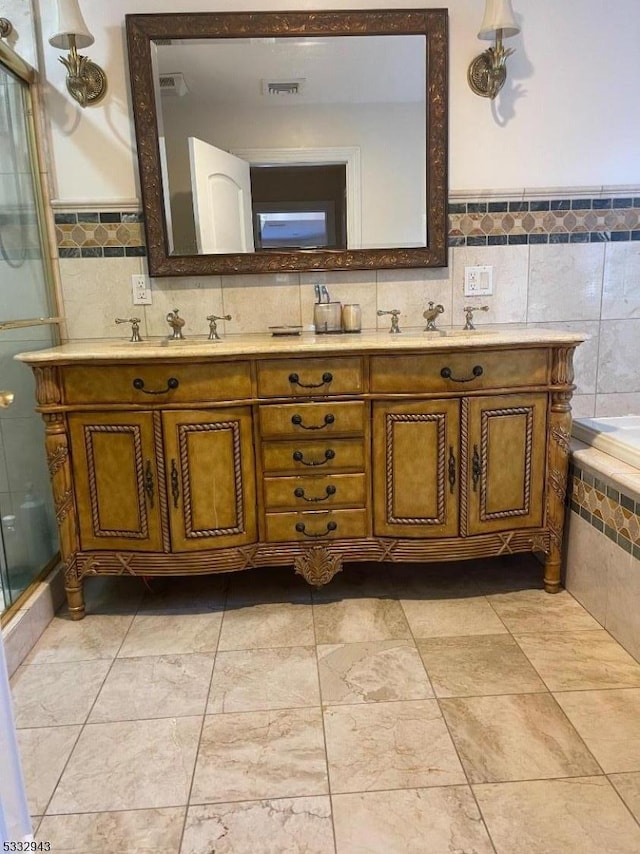 bathroom featuring tile walls, vanity, and shower with separate bathtub