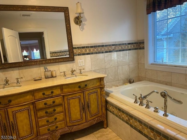 bathroom featuring vanity, tile patterned flooring, tile walls, and tiled tub