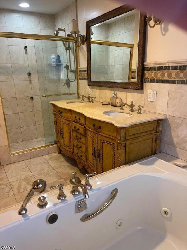 bathroom with vanity, tile walls, and separate shower and tub