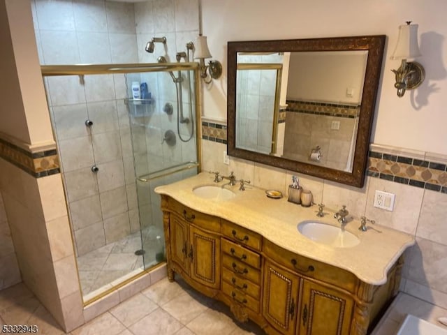 bathroom featuring tile walls, tile patterned floors, walk in shower, and vanity