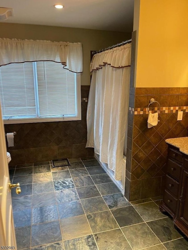 bathroom featuring tile walls and vanity