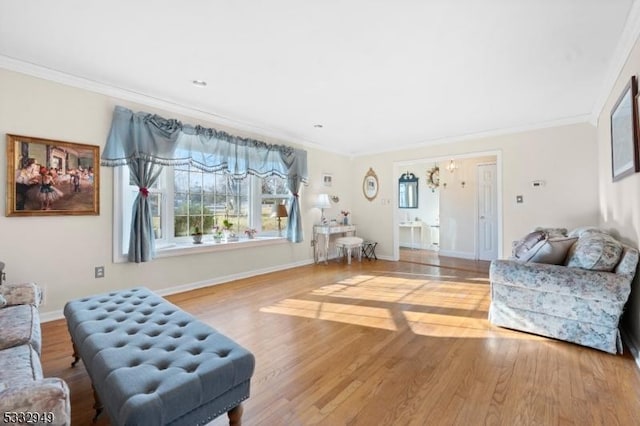 living room with crown molding and light hardwood / wood-style floors