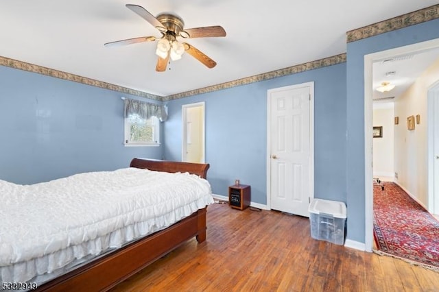 bedroom with ceiling fan and dark hardwood / wood-style flooring