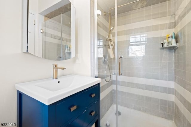 bathroom with vanity and a shower with door