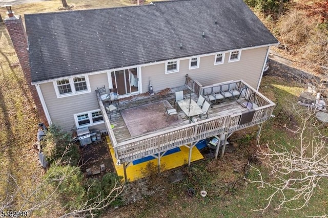 back of house featuring a wooden deck