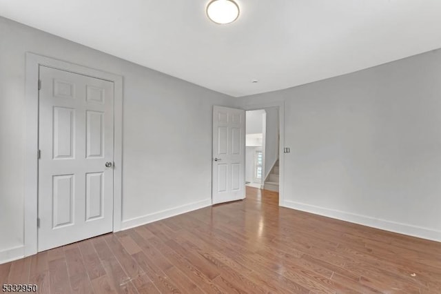 spare room featuring wood-type flooring