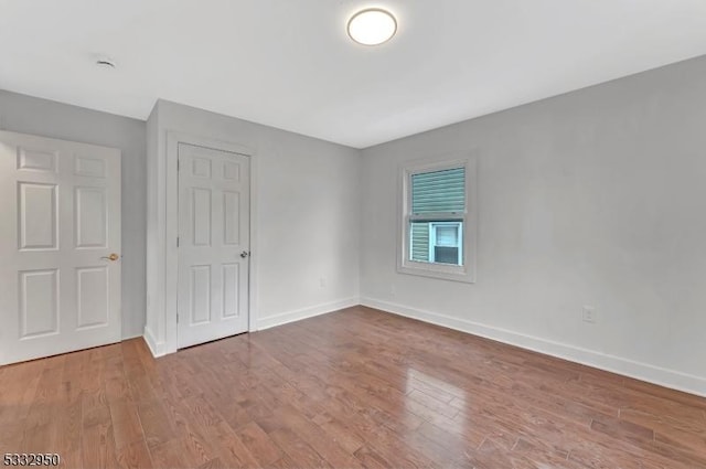 unfurnished bedroom featuring hardwood / wood-style flooring