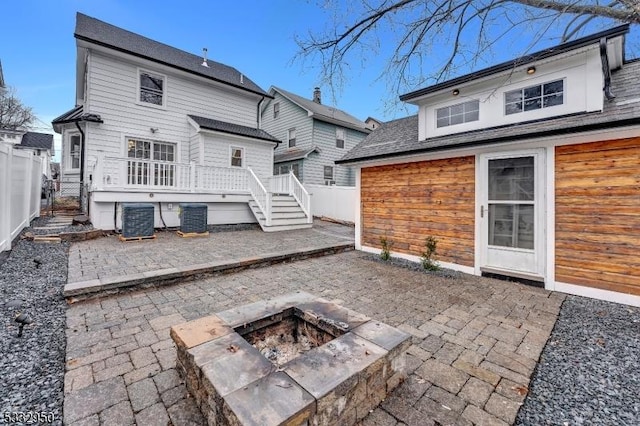 rear view of house with an outdoor fire pit, a patio area, and central air condition unit