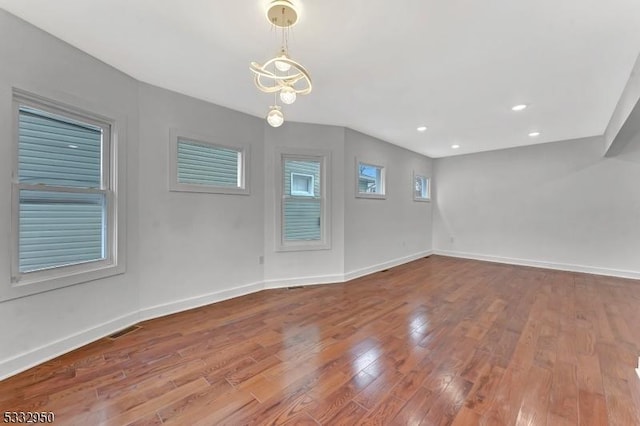 spare room with wood-type flooring