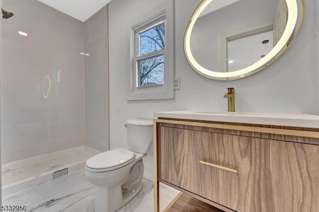 bathroom featuring a shower, vanity, and toilet