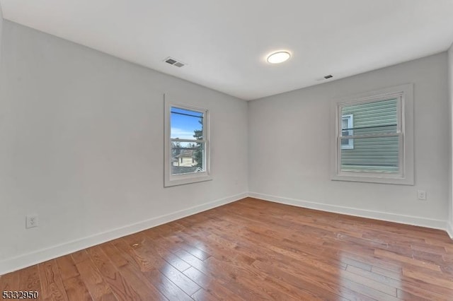 spare room with light wood-type flooring