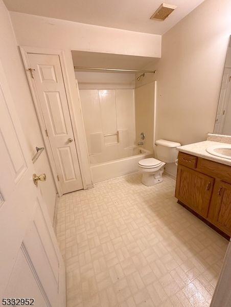 full bathroom featuring toilet, bathtub / shower combination, and vanity