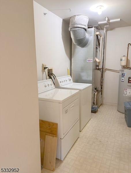 laundry area with separate washer and dryer and electric water heater