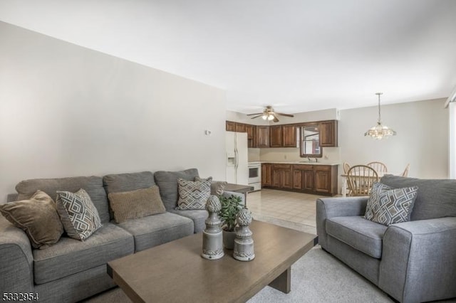 living room with ceiling fan with notable chandelier