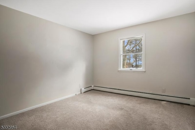 empty room featuring carpet flooring and a baseboard heating unit