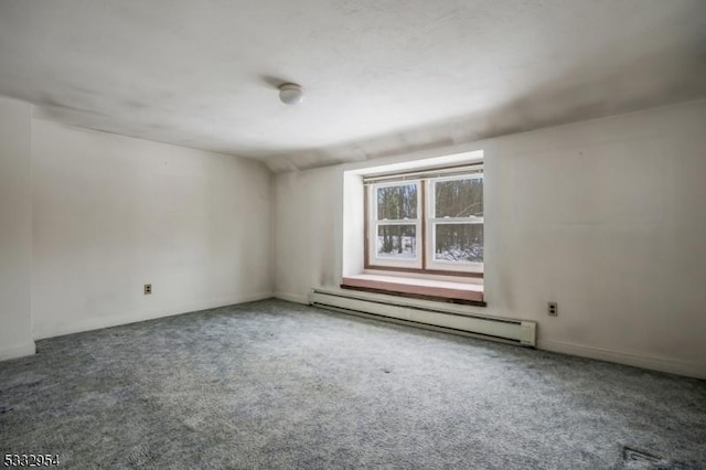 empty room with carpet floors and a baseboard heating unit