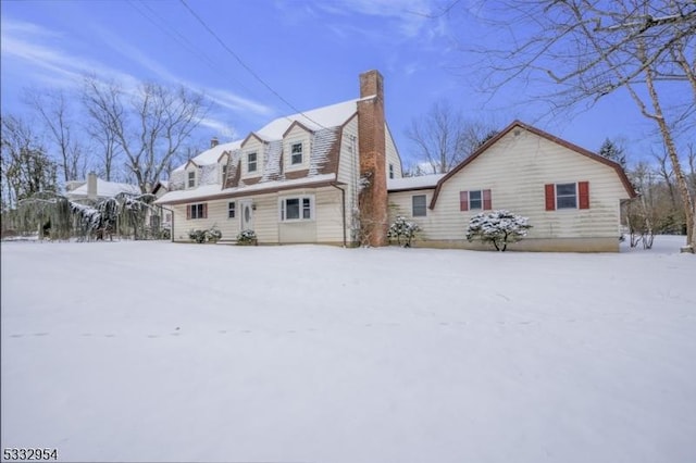 view of snow covered back of property