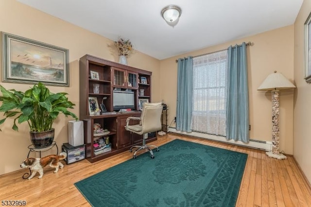 office area with wood-type flooring and a baseboard radiator