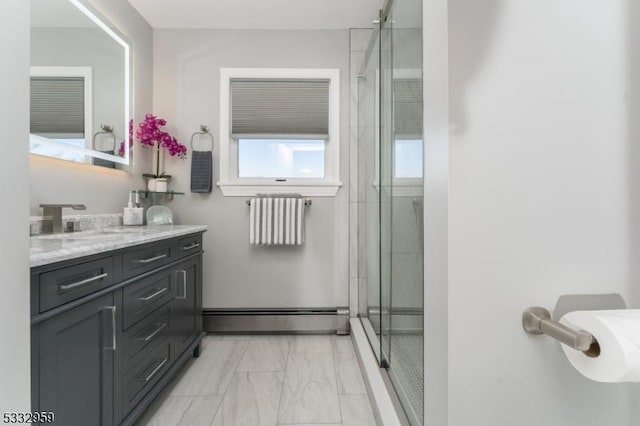 bathroom featuring vanity, baseboard heating, and a shower with door