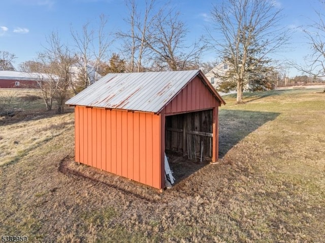 view of outbuilding with a yard