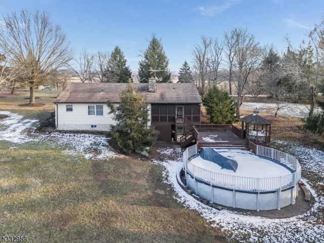 back of house with a sunroom and a swimming pool side deck