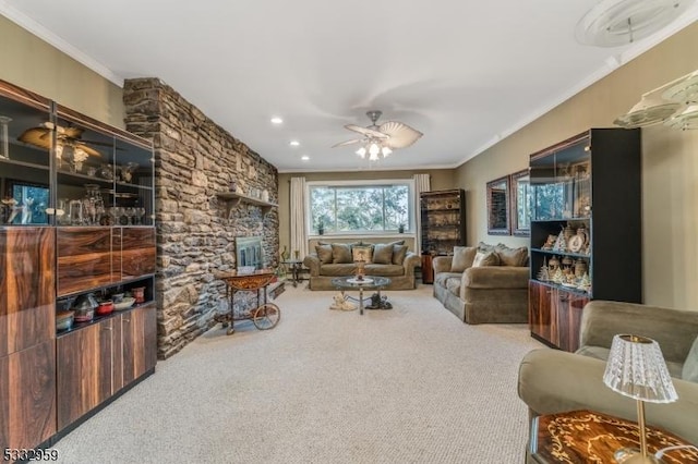 living room featuring ceiling fan, crown molding, and carpet floors