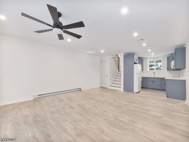 unfurnished living room featuring ceiling fan, light hardwood / wood-style flooring, and a baseboard radiator