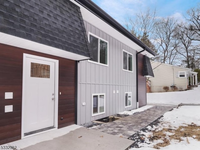 view of snowy exterior featuring a garage