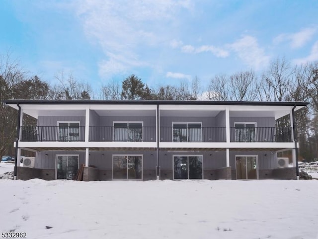 view of snow covered back of property