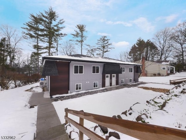 view of snow covered rear of property