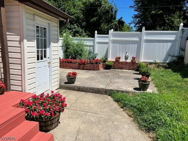 view of patio featuring a shed