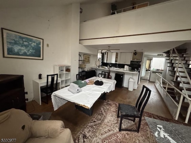 dining space featuring high vaulted ceiling, ceiling fan, and dark hardwood / wood-style floors