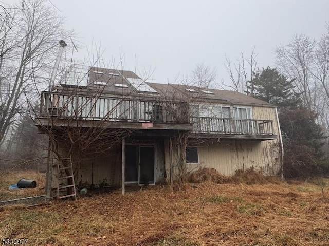 back of house featuring a deck