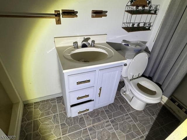 bathroom featuring tile patterned flooring, vanity, and toilet