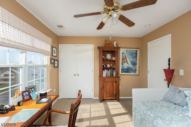 home office with ceiling fan and light colored carpet