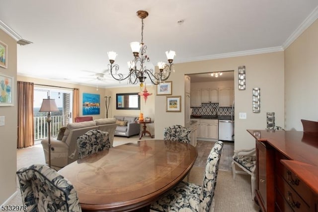 dining space with ceiling fan with notable chandelier and crown molding