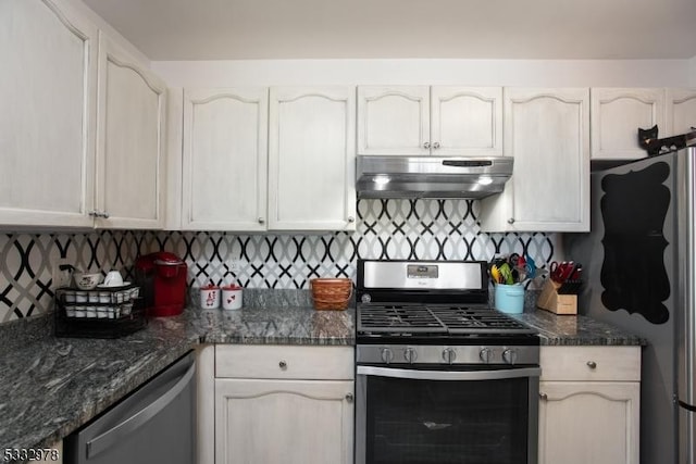 kitchen with appliances with stainless steel finishes, decorative backsplash, dark stone countertops, and white cabinets