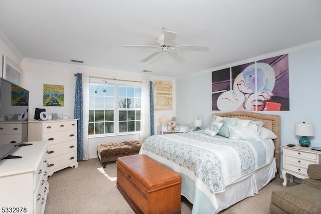 carpeted bedroom with ceiling fan and ornamental molding