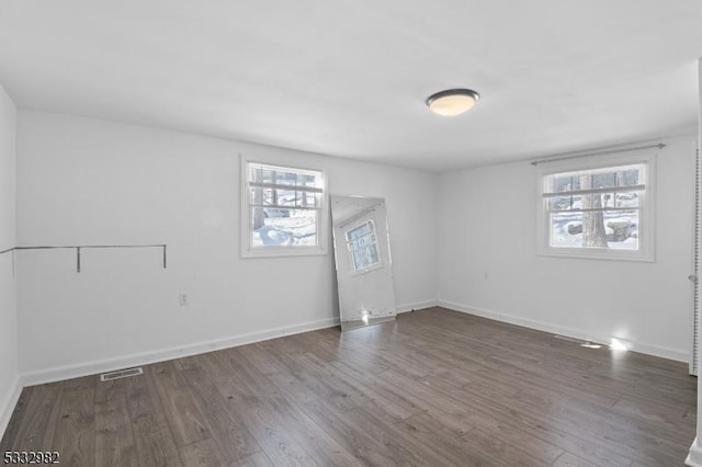 spare room featuring dark hardwood / wood-style flooring